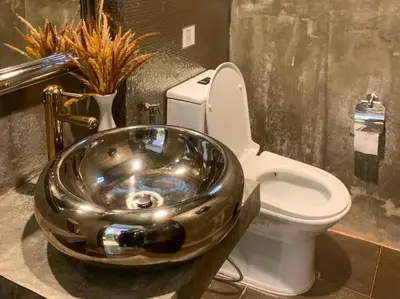 a bathroom with a toilet and a bowl sink at Aspira D'Andora Sukhumvit 16 - Asoke in Bangkok
