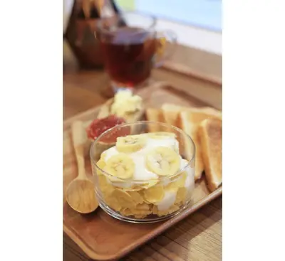 a tray of food with bananas and bread on it at Lamurr Sukhumvit 41 in Bangkok