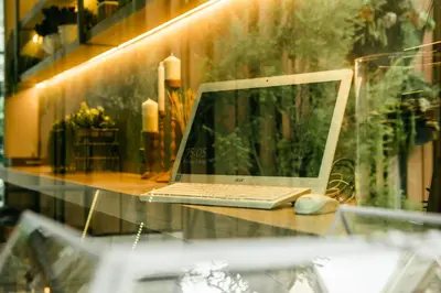 a laptop computer sitting on top of a glass table at NAP Hotel Bangkok in Bangkok