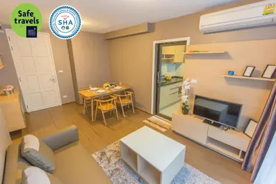 a living room with a couch and a tv and a table at Like Sukhumvit 22 in Bangkok