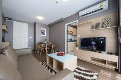 a living room with a couch and a tv at Like Sukhumvit 22 in Bangkok