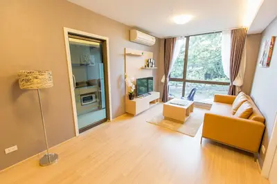 a living room with a couch and a window at Like Sukhumvit 22 in Bangkok
