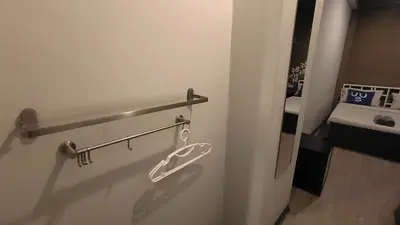 a bathroom with a towel rack and a sink at Bed's Friend in Bangkok