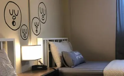 a bedroom with a bed with a lamp and a pillow at Bed's Friend in Bangkok