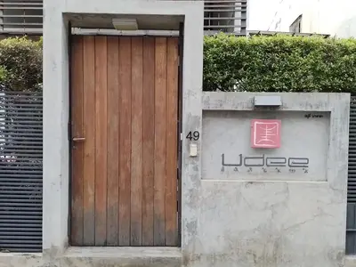 a wooden door on the side of a building at Udee Bangkok Hostel in Bangkok