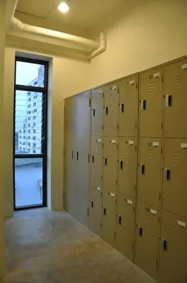 a row of lockers in a room with a window at Udee Bangkok Hostel in Bangkok