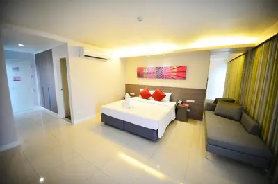 a large bedroom with a bed and a couch at Praso@Ratchada12 in Bangkok