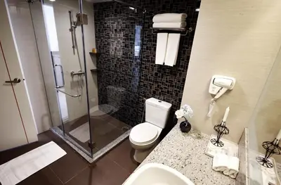 a bathroom with a shower and a toilet and a sink at Praso@Ratchada12 in Bangkok
