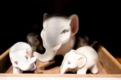 a figurine of an elephant and three smaller elephants at Check-in My Hostel in Bangkok