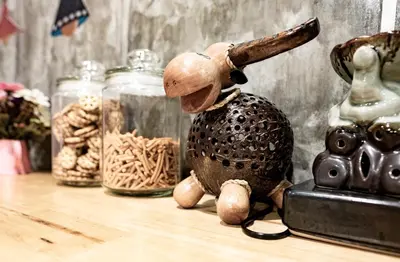 a toy rabbit sitting on a table with a gun on its back at Check-in My Hostel in Bangkok