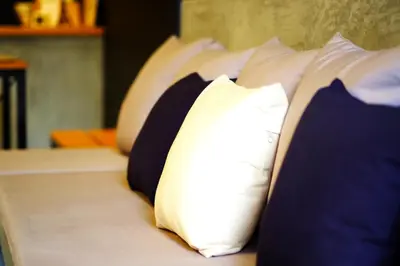 a row of pillows sitting on a bed at The Backpack Hostel in Bangkok