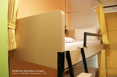 a room with a bunk bed and a mirror at Bed@Town Hostel in Bangkok