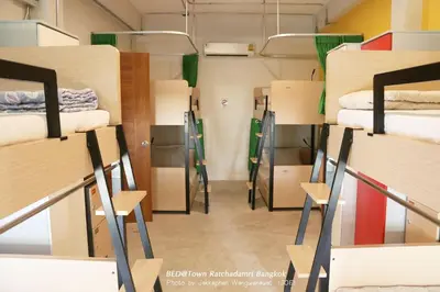 a room filled with lots of bunk beds at Bed@Town Hostel in Bangkok