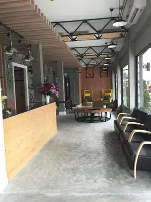 a lobby with couches and a table and chairs at Bed@Town Hostel in Bangkok