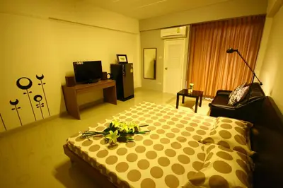 a bedroom with a bed with flowers on it at At Home Phetkasem in Bangkok