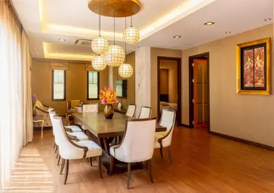 a dining room with a table and chairs at Chiva Bangkok Hotel in Bangkok