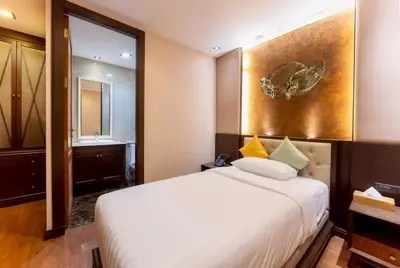 a hotel room with a bed and a sink at Chiva Bangkok Hotel in Bangkok
