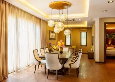 a dining room with a table and chairs at Chiva Bangkok Hotel in Bangkok