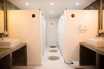 a bathroom with two sinks and two mirrors at Movylodge in Bangkok
