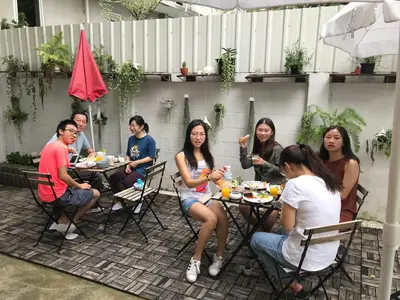 a group of people sitting around a table at Movylodge in Bangkok
