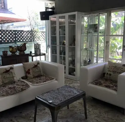 a living room with two white couches and a table at Oriental Smile Hotel in Bangkok
