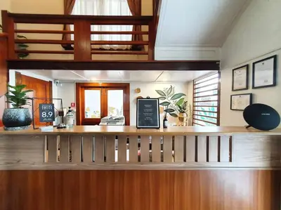 a lobby with a counter with a phone on it at Dinsomon Hotel in Bangkok
