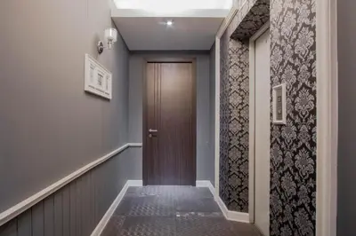 a hallway with a brown door and blue walls at The Star of Sathorn in Bangkok