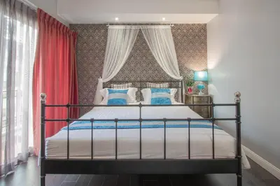 a bedroom with a bed with a red curtain at The Star of Sathorn in Bangkok