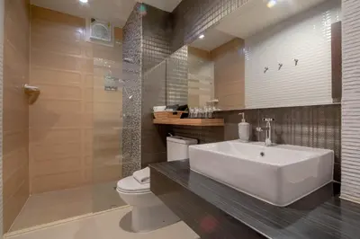 a bathroom with a sink and a toilet and a shower at The Star of Sathorn in Bangkok
