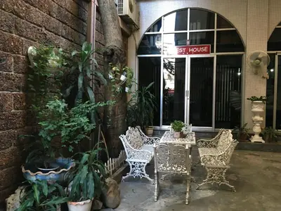 a group of chairs and a table in front of a building at The Grand Palace Hotel in Bangkok