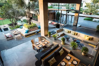 an overhead view of a living room with couches and tables at The Silver Palm Wellness Resort in Bangkok