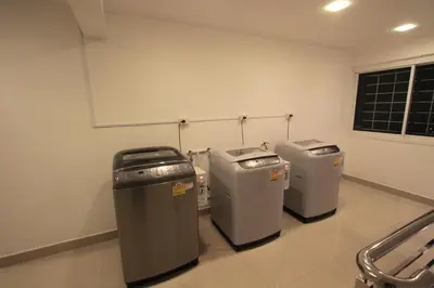 three trash cans sitting in a room at Napaville Huai Khwang in Bangkok