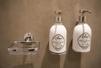 a couple of bottles of soap sitting on a counter at The Raweekanlaya Bangkok Wellness Cuisine Resort in Bangkok