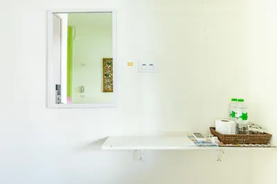 a bathroom with a white shelf and a mirror at Sleep Dee Hostel in Bangkok
