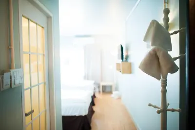 a bedroom with a bed and a lamp in a room at KENCOZY accommodation in Bangkok