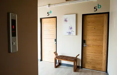 a room with a door and a bench next to it at KENCOZY accommodation in Bangkok