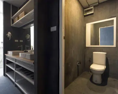 a bathroom with a toilet and a sink at On the Bed Hostel in Bangkok