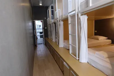 a room with a row of bunk beds in it at On the Bed Hostel in Bangkok