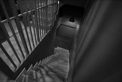 an overhead view of a staircase with a light at Yoo Yen Pen Sook in Bangkok