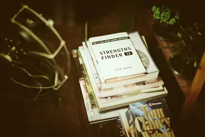 a stack of books sitting on a table at Yoo Yen Pen Sook in Bangkok