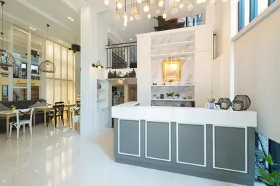 a kitchen and dining room with a table and chairs at White Ivory Bed And Breakfast in Bangkok
