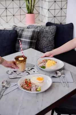 a table with two plates of food on it at White Ivory Bed And Breakfast in Bangkok