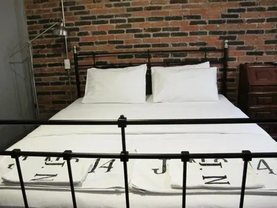 a bed in a room with a brick wall at J No.14 in Bangkok