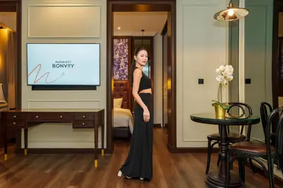 a woman in a black dress standing in a room at Metropole, Bangkok, a Tribute Portfolio Hotel by Marriott in Bangkok