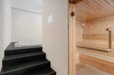 a sauna with black stairs and a tub at Metropole, Bangkok, a Tribute Portfolio Hotel by Marriott in Bangkok