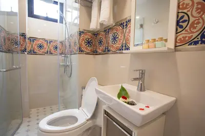 a bathroom with a toilet and a sink at Nine Design Place in Bangkok