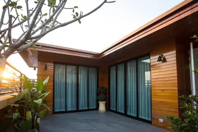 a modern house with wooden walls and windows at Nine Design Place in Bangkok