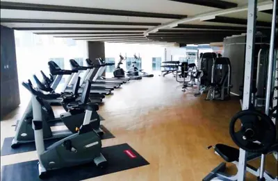 a gym with a row of treadmills and machines at Luxury Suite @ BTS Nana in Bangkok