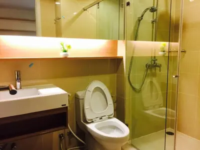 a bathroom with a toilet and a sink and a shower at Luxury Suite @ BTS Nana in Bangkok