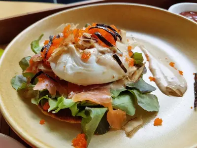 a plate with a salad with an egg on it at Zenniq in Bangkok